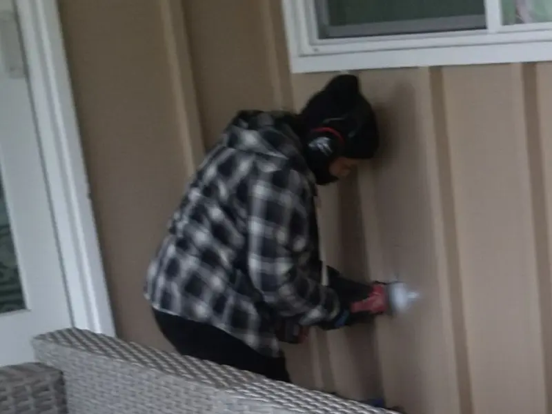 Professional electrician installing an exterior outlet in Farr West