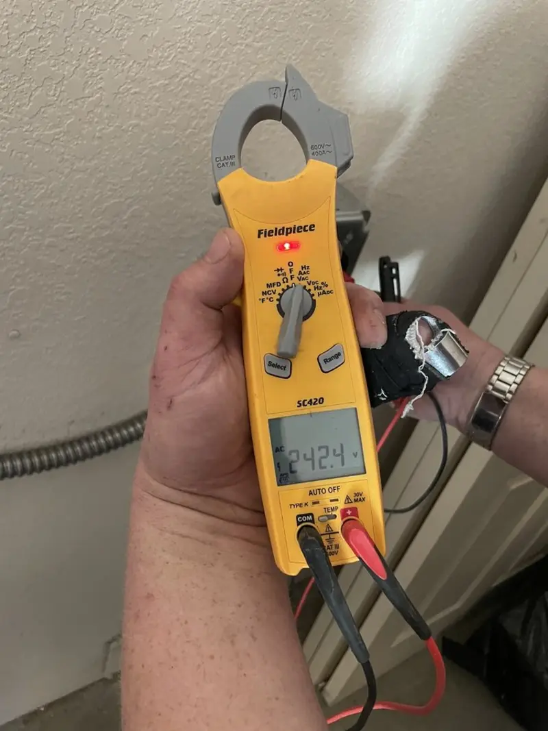 Voltage testing with clamp meter during Recessed Lighting Installation in Farr West
